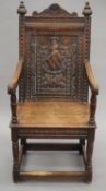 A 19th century carved oak open arm chair, the back panel carved with a Heraldic crest. 53.5 cm wide.