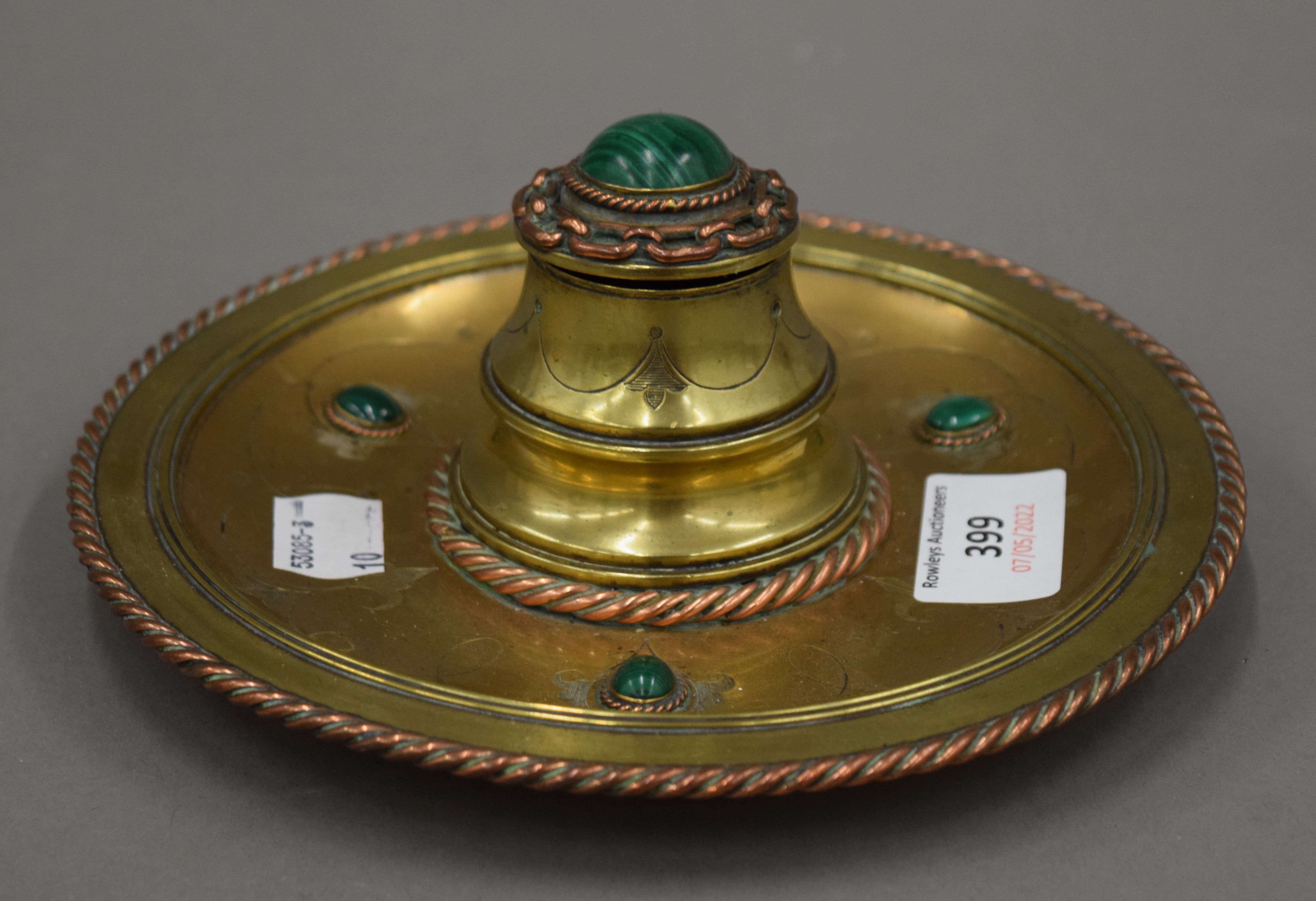 A Victorian brass and malachite inkwell. 17.5 cm diameter.