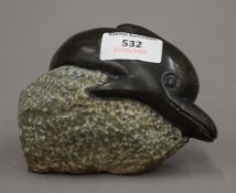 A Serpentine carving of a dolphin. 12 cm wide.