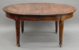 A Victorian mahogany two leaf extending dining table.