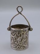 A silver model of a bucket. 2.5 cm high excluding handle.