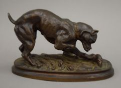 A patinated bronze figure of a dog hunting a rat. 16 cm long.