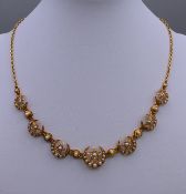 An unmarked gold and seed pearl star and crescent necklace. 40 cm long. 18.8 grammes total weight.