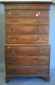 A George III mahogany chest on chest with Greek key pattern cornice, standing on bracket feet.