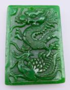 A jade dragon form pendant. 6 cm x 4.25 cm.