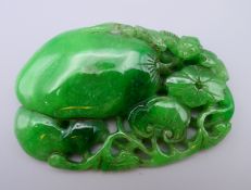 A jade pedant formed as a bat and fruit. 8.5 cm x 6 cm.