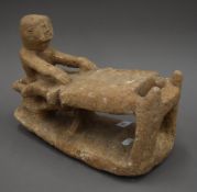 A carved Innuit figure on a sledge. 34 cm long.