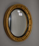 A gilt framed convex wall glass. 31.5 cm diameter.