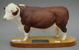 A Beswick Polled Hereford Bull, standing on a wooden base. 19 cm high.