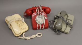 Three vintage telephones.