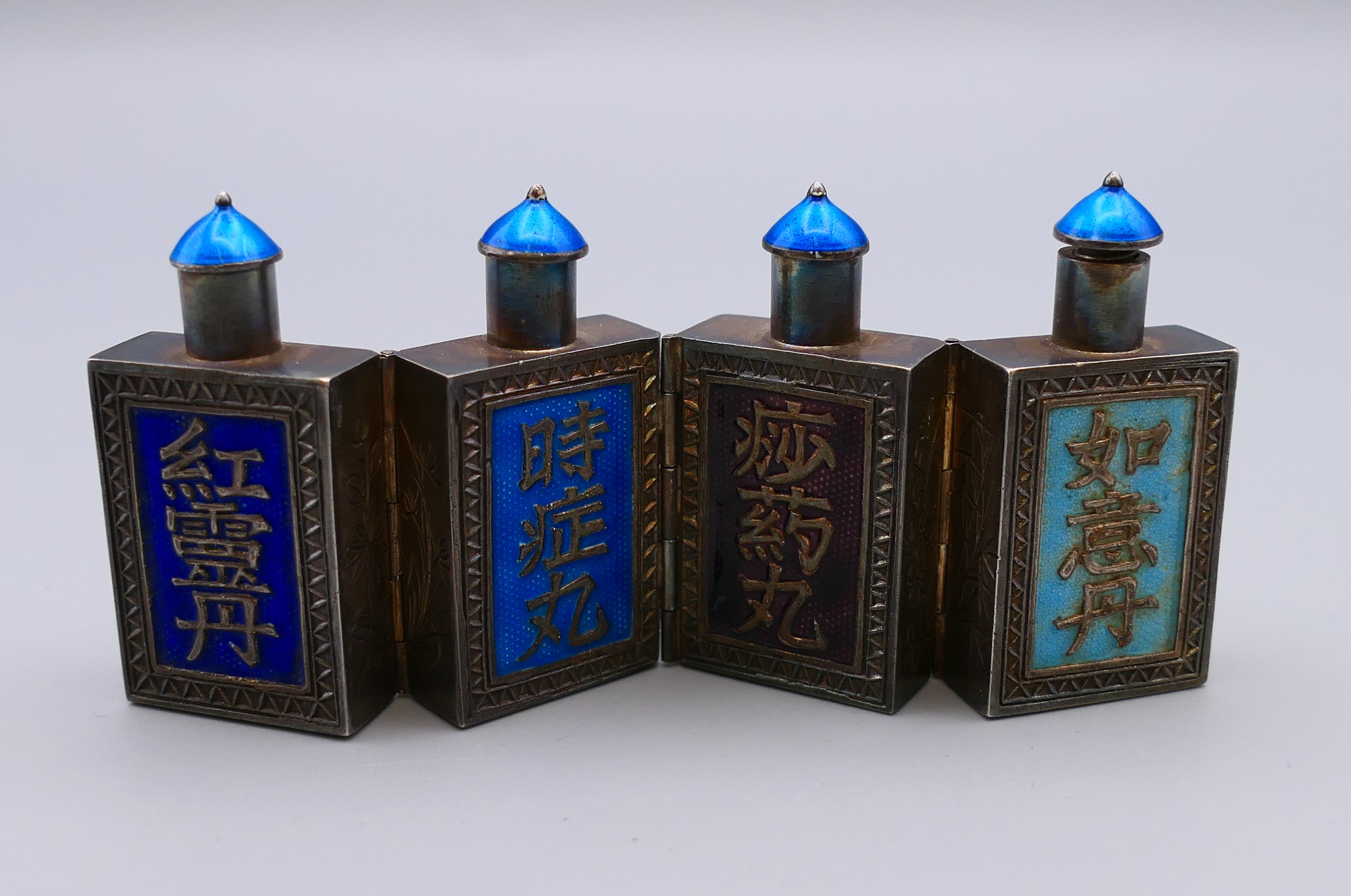 A set of four Chinese silver and enamel folding hinged snuff bottles. 4 cm high, 8 cm long opened. - Image 3 of 9