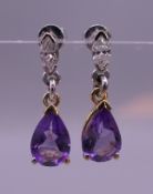 A pair of 18 ct gold, amethyst and trillion cut diamond drop earrings. 2 cm high.