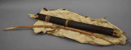 A bow and bone tipped arrows, arrow carrier and wallaby skin water carrier.