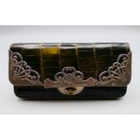 A crocodile skin purse with silver mounts. 12 cm long x 6 cm high.