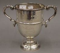 A twin handled silver cup for The Essex Farmers Hunt Steeple Chases. 21 cm high. 17.5 troy ounces.
