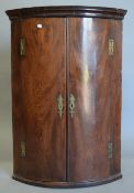 A George III mahogany corner cupboard. 71.5 cm wide.