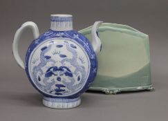 A Chinese blue and white porcelain teapot and an Art pottery vase. The former 25 cm high.