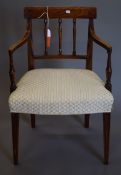 A 19th century elm upholstered open arm chair. 56 cm wide.