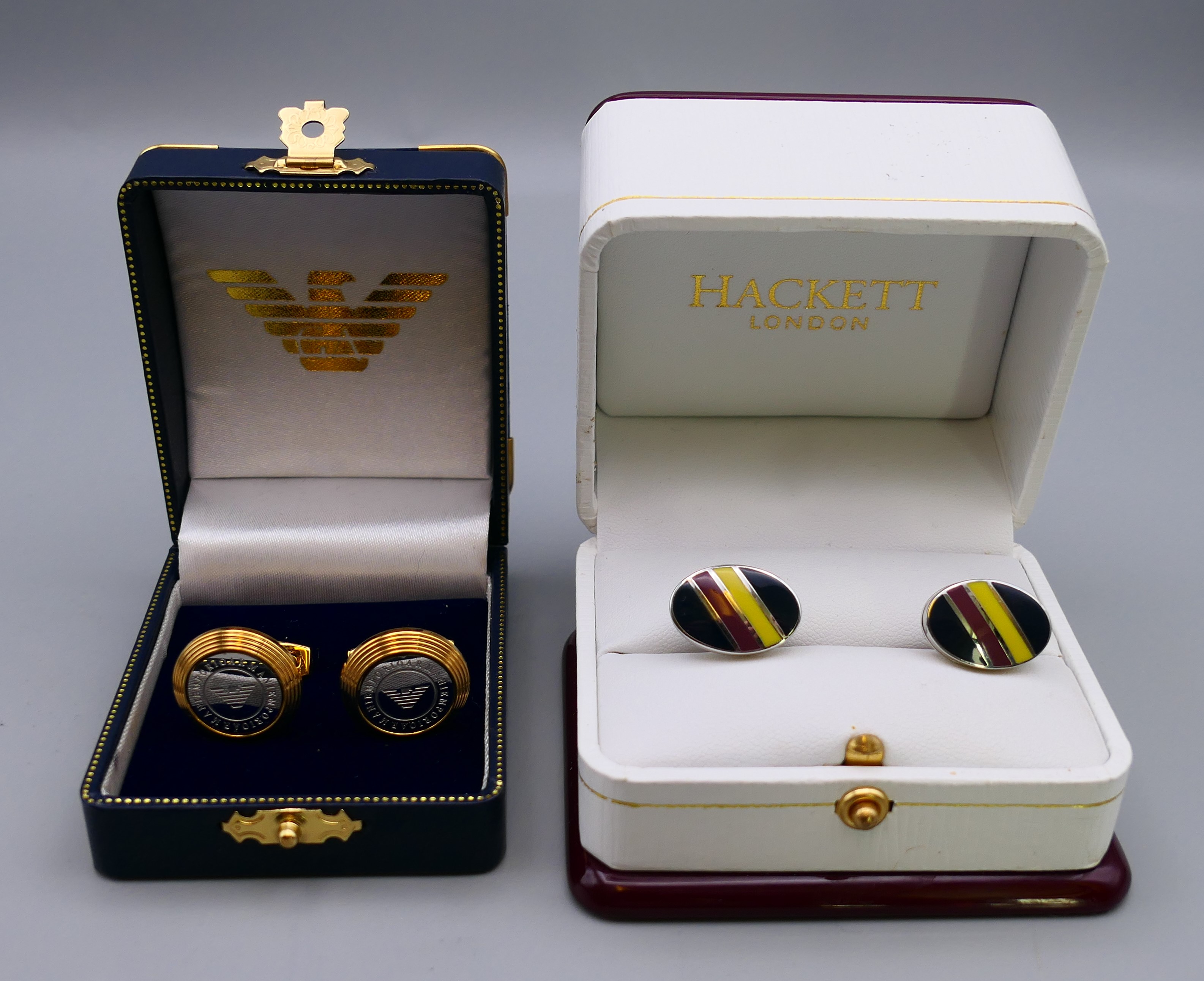 A pair of Hackett cufflinks and a pair of Armani cufflinks, both boxed.