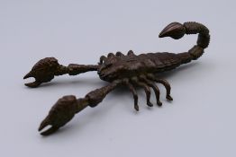 A bronze articulated model of a scorpion. 9 cm long.