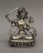 A Tibetan silvered bronze figure of Manjushri, with star mark to base. 20.5 cm high.