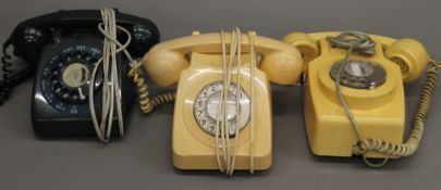 A box of various vintage telephones.