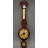 A wooden banjo barometer. 66.5 cm high.