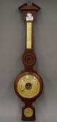 A wooden banjo barometer. 66.5 cm high.