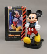 A boxed Mickey Mouse novelty telephone.