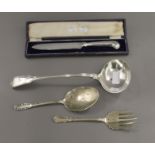 A cased cake knife, a plated ladle and plated salad servers.