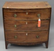 A George IV mahogany bow front chest of three long graduated drawers. 77 cm wide.