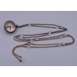 An E Gubelin pendant ball watch on long chain. Watch 2 cm diameter, chain 86 cm long.