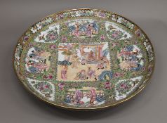 A large Canton famille rose ceramic charger. 56 cm diameter.
