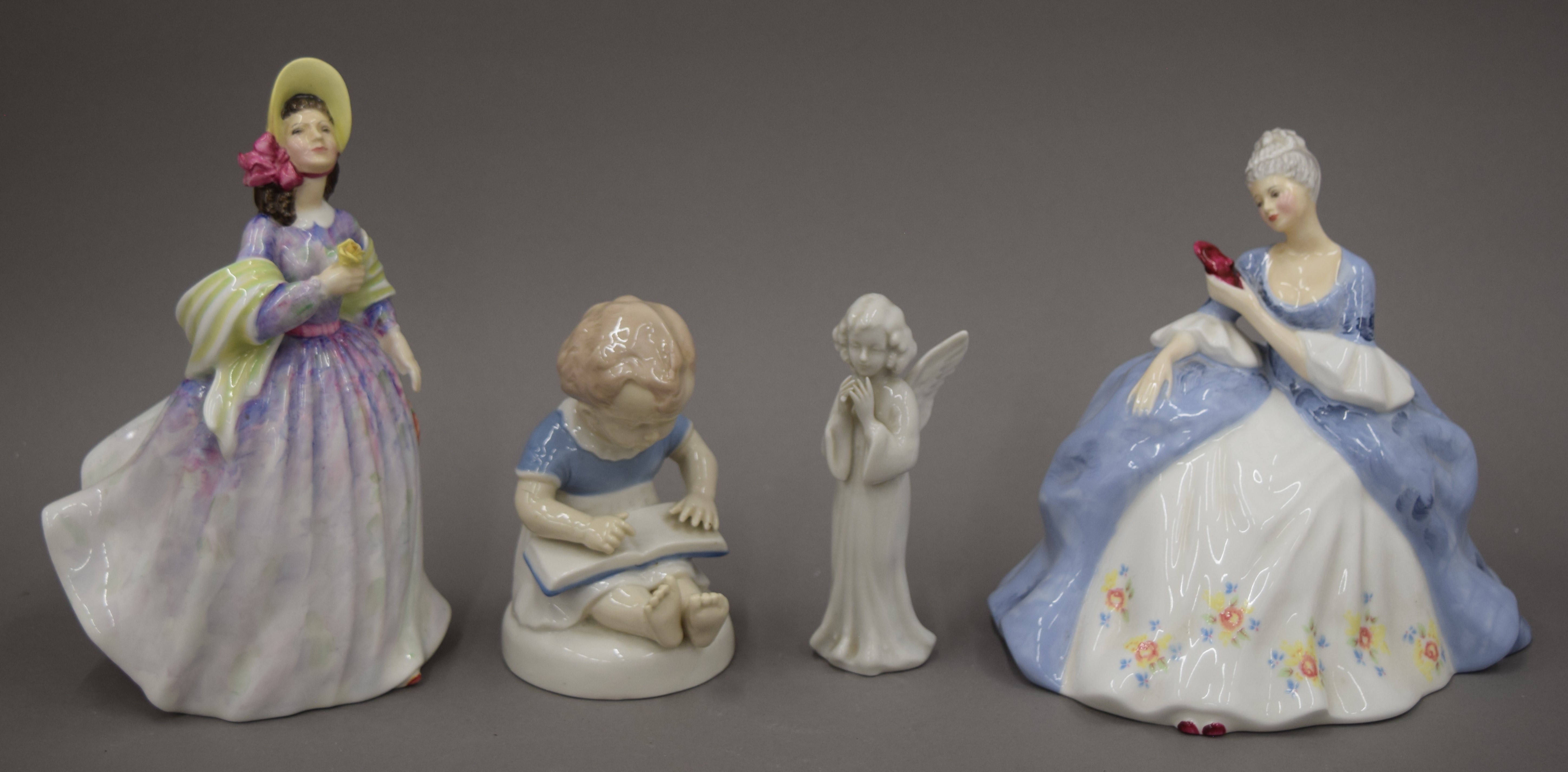 Two Doulton porcelain figurines and two other figurines.