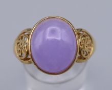 A 14 K gold ring with lilac coloured stone. Ring size U/V. 4 grammes total weight.