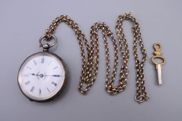 A 935 silver pocket watch, a silver chain and a key. Watch 3.75 cm diameter, chain 78 cm long.