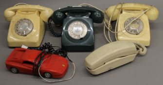 A box of various vintage telephones.