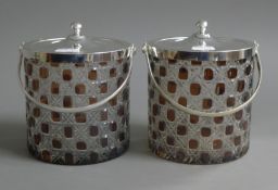 A pair of cut glass biscuit barrels. 13 cm high.