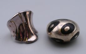 Two modern silver rings.