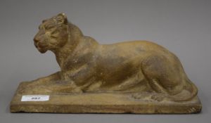 A carved stone model of a recumbent lioness. 26.5 cm long.