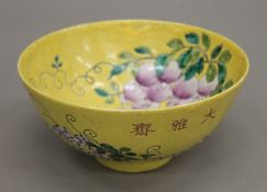 A Chinese porcelain yellow ground bowl. 15 cm diameter.