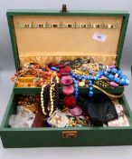 A jewellery box containing a large quantity of costume jewellery.