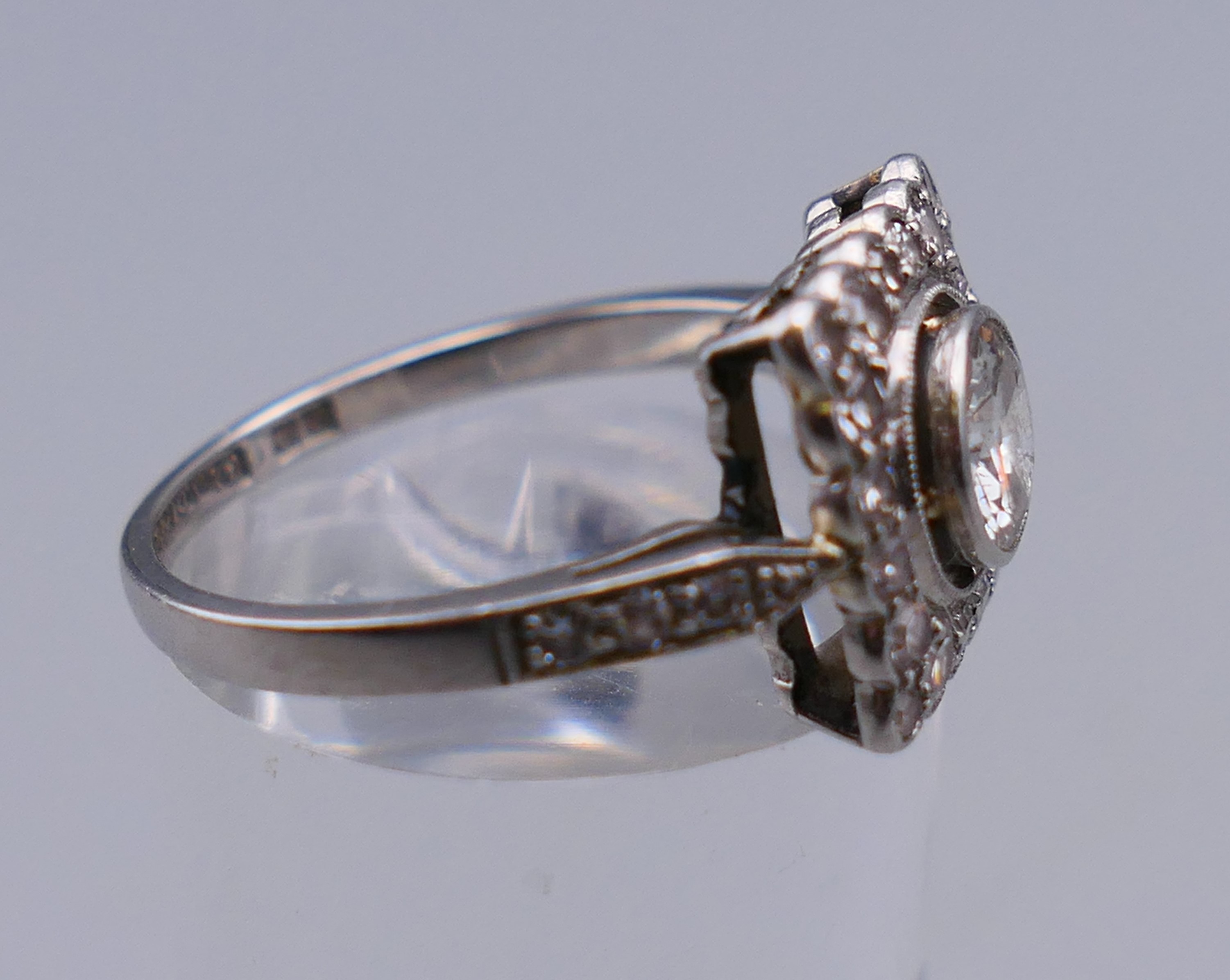 A platinum and diamond ring, the central stone spreading to just under 0.75 of a carat. - Image 6 of 6