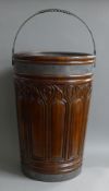 A large carved wooden bucket. 56 cm high.