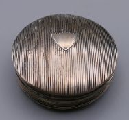 A Continental silver circular snuff box. 5 cm diameter.