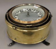 A large brass binnacle compass by Kelvin Hughes Ltd. 34 cm diameter.