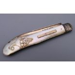 A mother-of-pearl and silver fruit knife. 9 cm long.