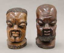 A pair of African carved wooden busts. The largest 24 cm high.