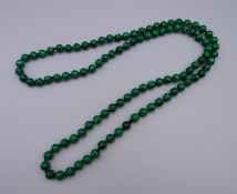 A string of malachite beads. Approximately 90 cm long.