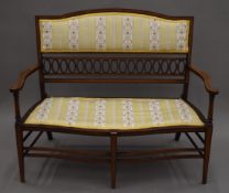 An Edwardian line inlaid mahogany salon settee. 110 cm long.